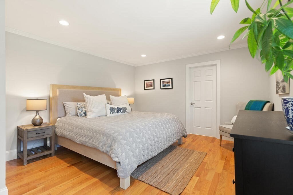 19 Foster Street, Unit 19 Arlington, MA 02474 - Photo 15 of 33 a bedroom with a bed and a potted plant