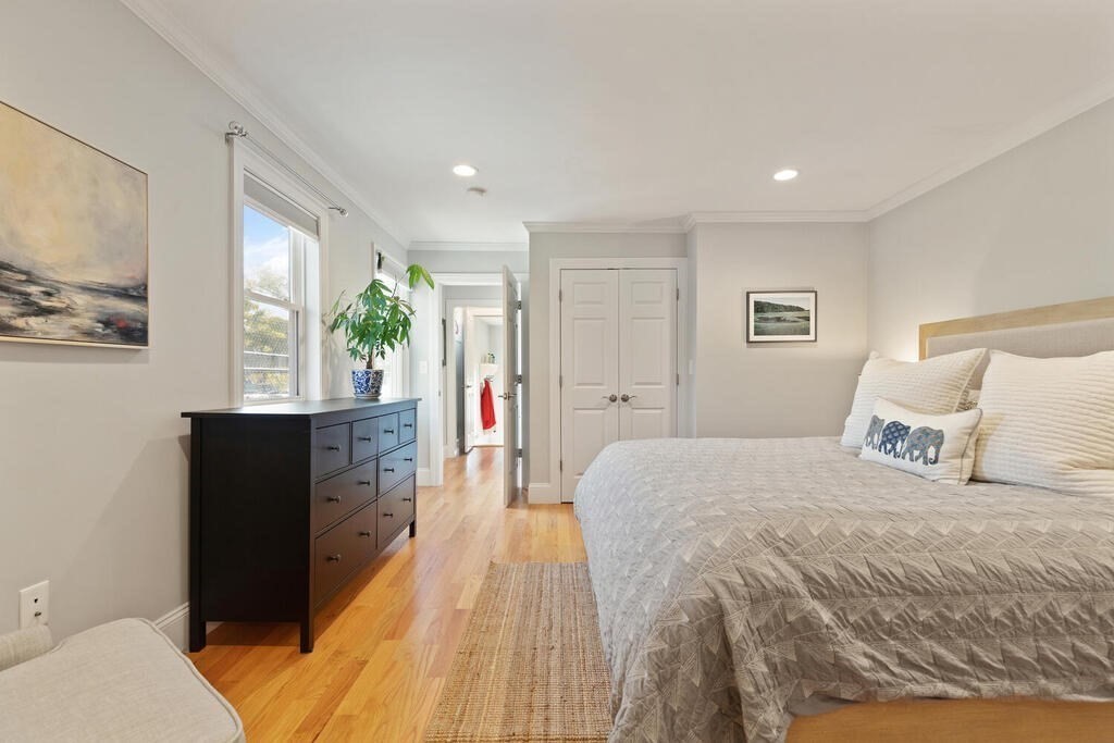 19 Foster Street, Unit 19 Arlington, MA 02474 - Photo 16 of 33 a spacious bedroom with a bed and a large window