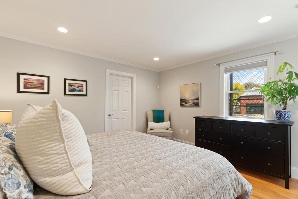 19 Foster Street, Unit 19 Arlington, MA 02474 - Photo 17 of 33 a bedroom with a large bed and a dresser
