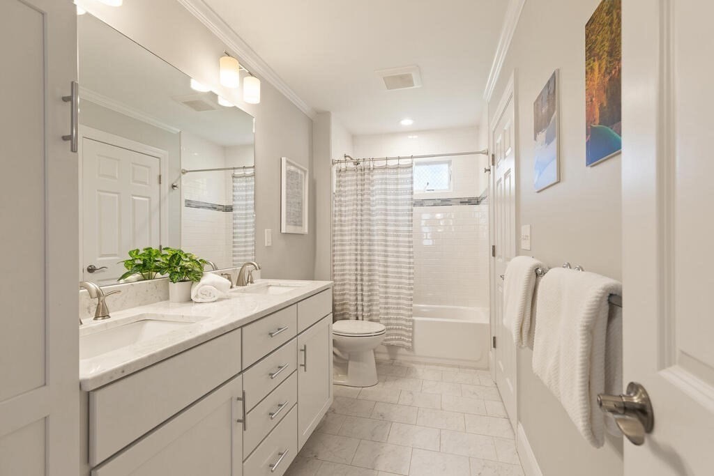 19 Foster Street, Unit 19 Arlington, MA 02474 - Photo 18 of 33 a bathroom with a double vanity sink toilet and shower