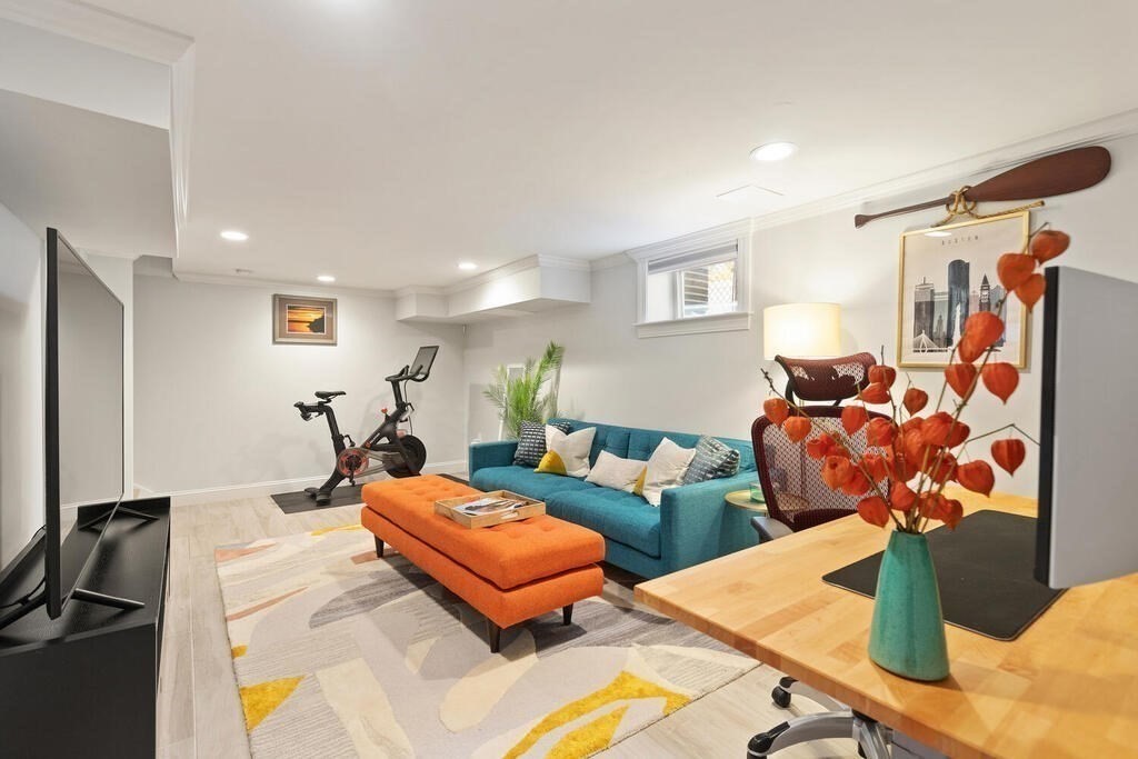 19 Foster Street, Unit 19 Arlington, MA 02474 - Photo 23 of 33 a living room with furniture a rug and a lamp