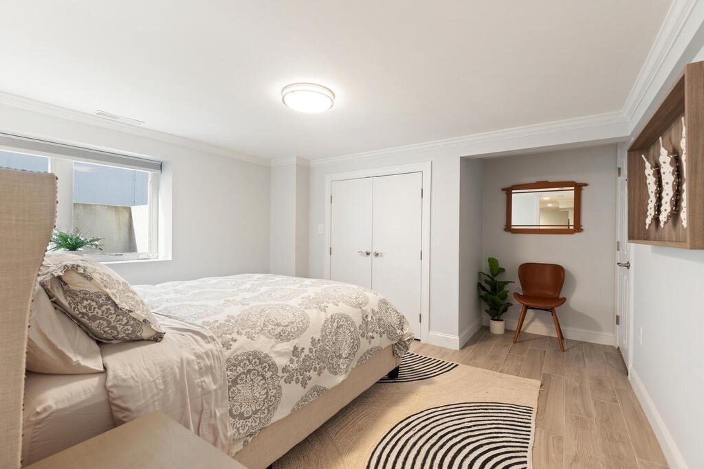 19 Foster Street, Unit 19 Arlington, MA 02474 - Photo 25 of 33 a bedroom with a bed and chair