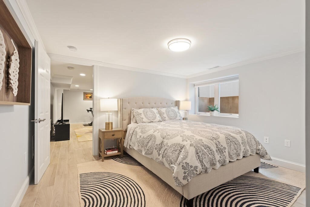 19 Foster Street, Unit 19 Arlington, MA 02474 - Photo 26 of 33 a bedroom with a bed and a walk in closet