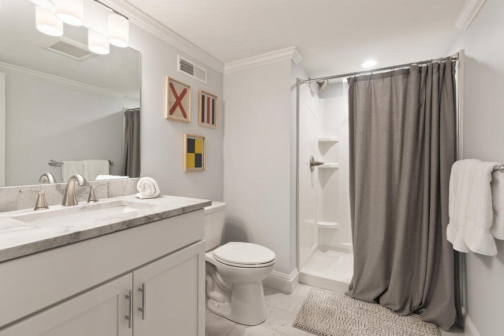 19 Foster Street, Unit 19 Arlington, MA 02474 - Photo 27 of 33 a bathroom with a granite countertop sink toilet and shower