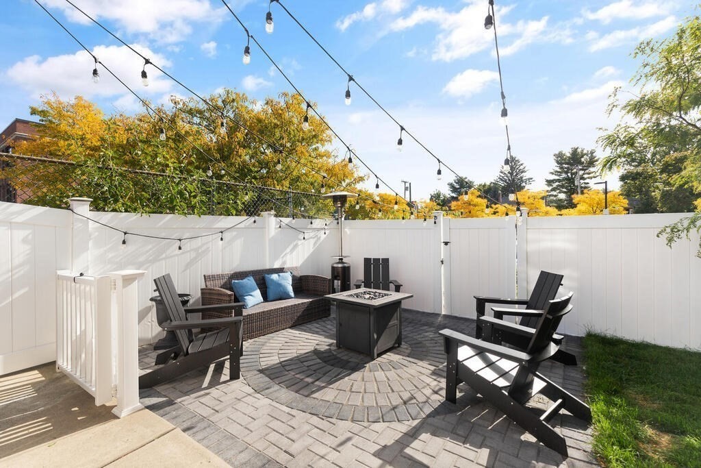 19 Foster Street, Unit 19 Arlington, MA 02474 - Photo 30 of 33 a view of a patio with table and chairs with wooden floor
