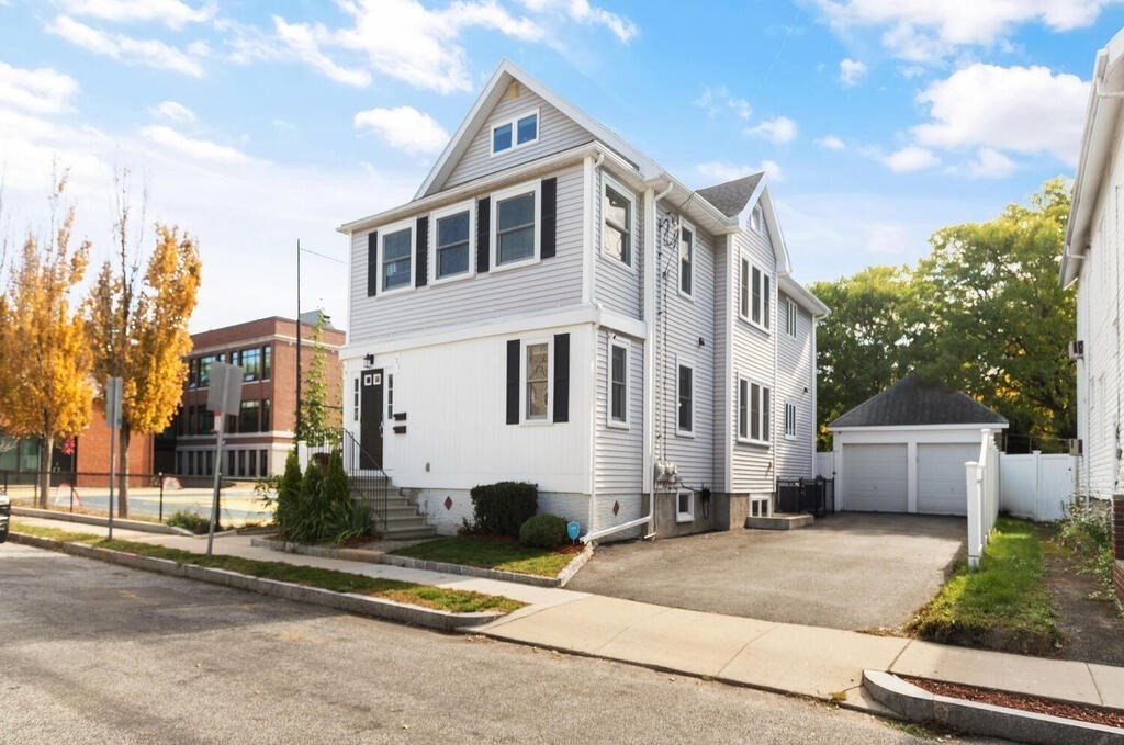 19 Foster Street, Unit 19 Arlington, MA 02474 - Photo 3 of 33 a view of a white building among the street with palm trees