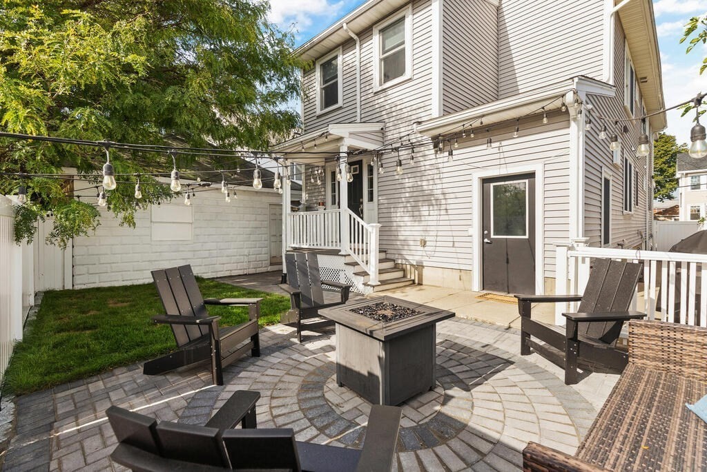 19 Foster Street, Unit 19 Arlington, MA 02474 - Photo 4 of 33 a view of a patio with table and chairs and potted plants