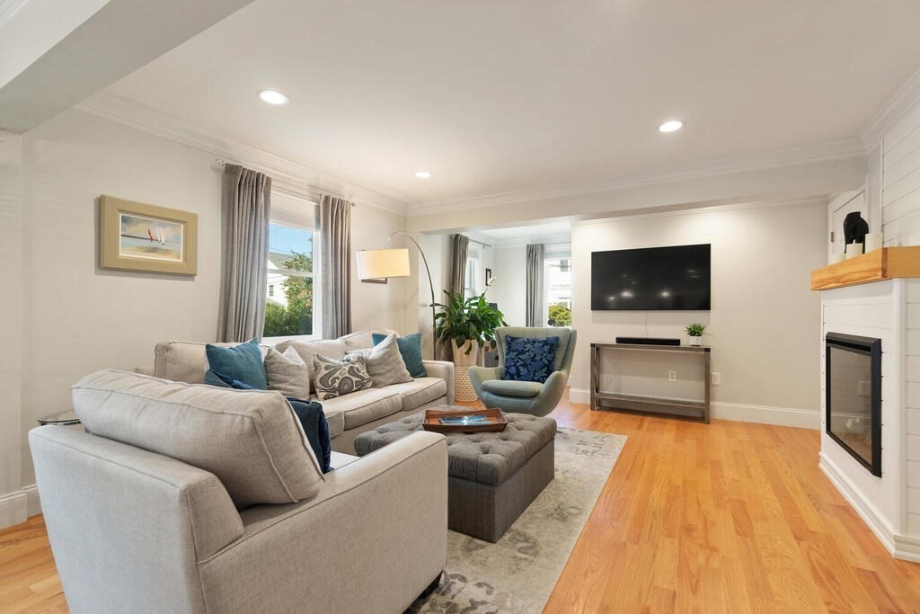 19 Foster Street, Unit 19 Arlington, MA 02474 - Photo 6 of 33 a living room with fireplace furniture and a flat screen tv