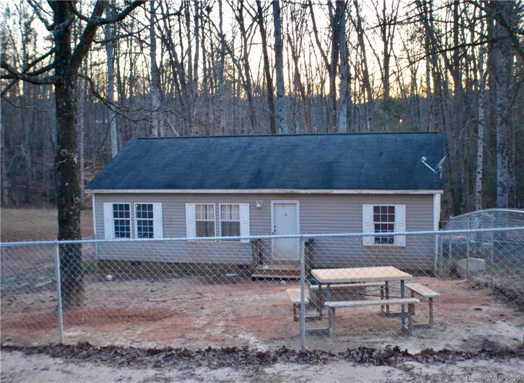 front view of a house with a yard and sitting area