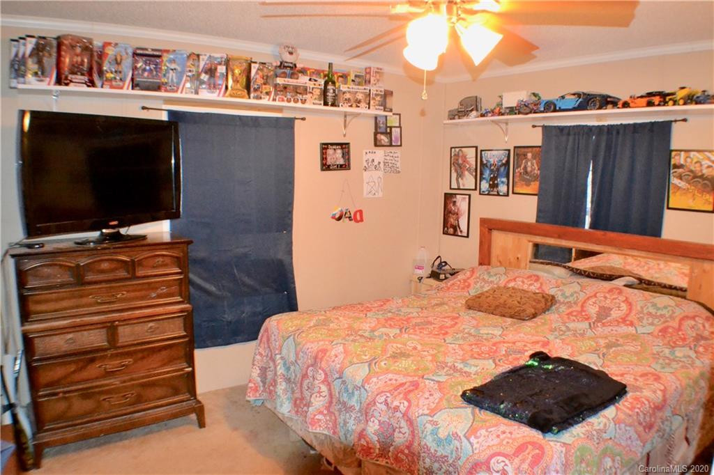 115 Cold Springs Drive Mill Spring, NC 28756 - Photo 11 of 19 a bedroom with a bed and a flat screen tv