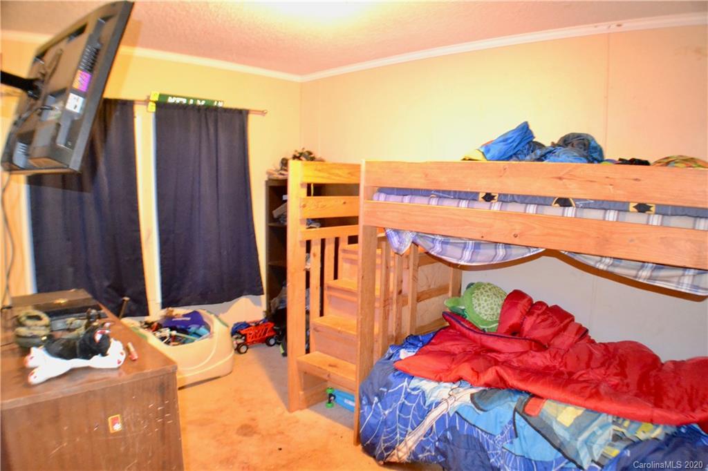 115 Cold Springs Drive Mill Spring, NC 28756 - Photo 12 of 19 a view of a balcony with chair and table