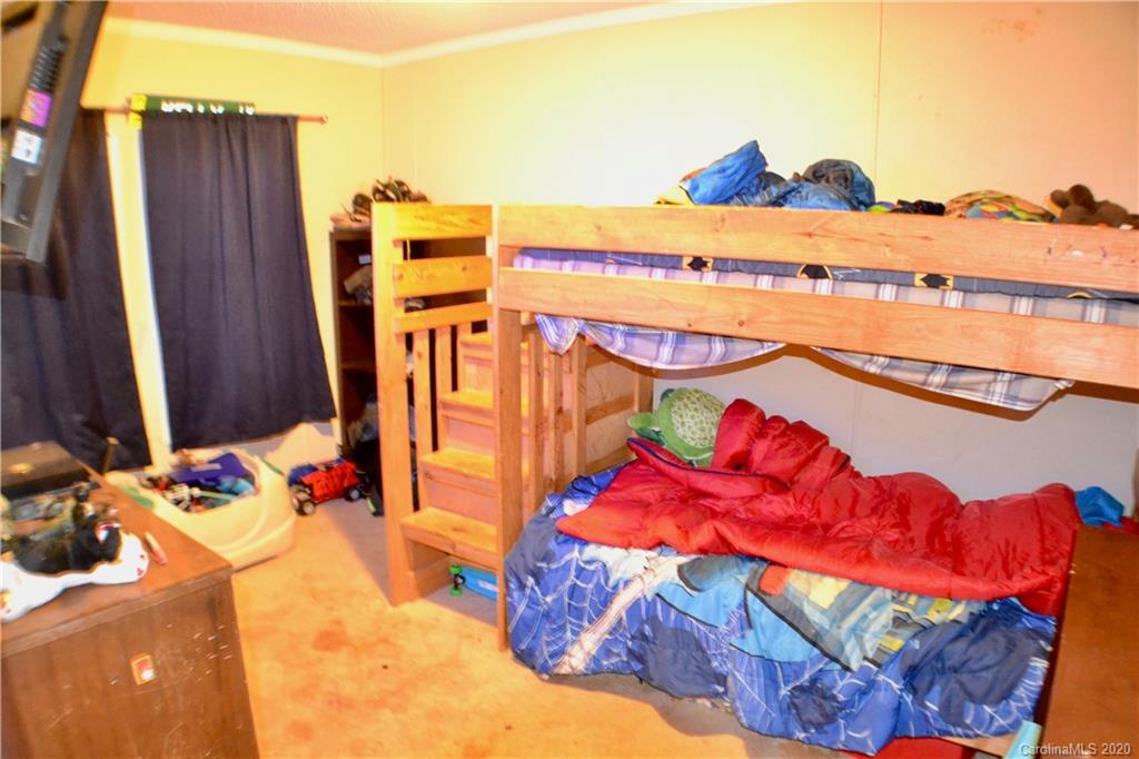115 Cold Springs Drive Mill Spring, NC 28756 - Photo 13 of 19 a view of a balcony with dining table and chairs