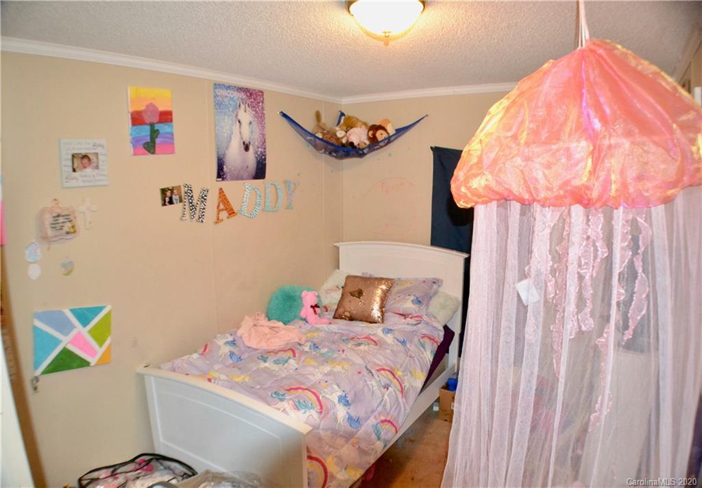 115 Cold Springs Drive Mill Spring, NC 28756 - Photo 15 of 19 a bedroom with a bed and a window