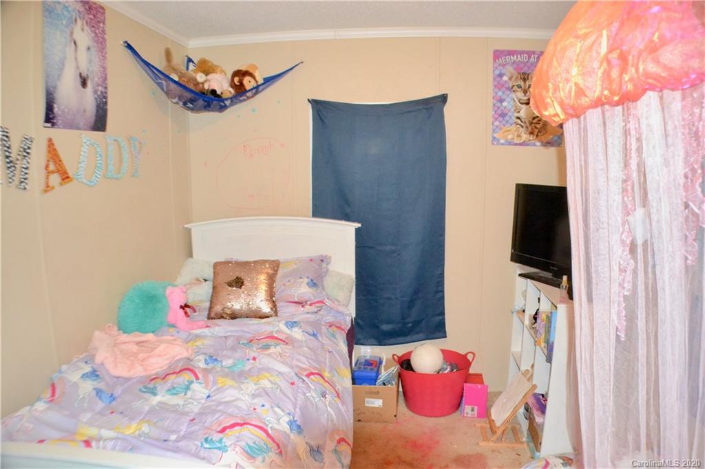 115 Cold Springs Drive Mill Spring, NC 28756 - Photo 16 of 19 a bedroom with a bed and a flat screen tv