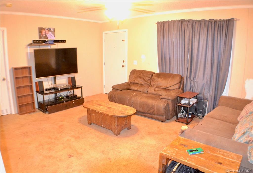 115 Cold Springs Drive Mill Spring, NC 28756 - Photo 3 of 19 a living room with furniture and a flat screen tv