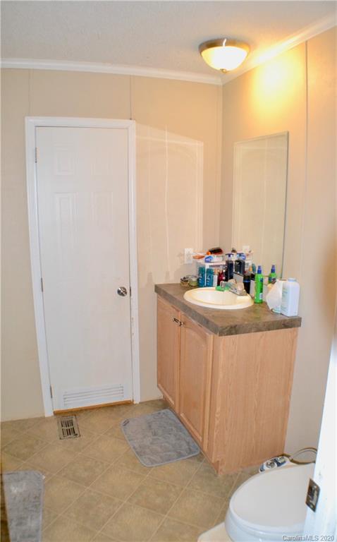 115 Cold Springs Drive Mill Spring, NC 28756 - Photo 10 of 19 a bathroom with a sink a toilet a mirror and shower