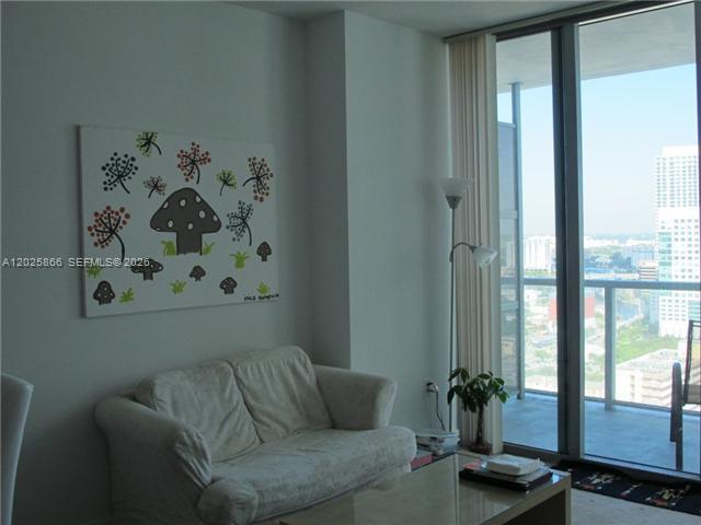 79 Southwest 12th Street, Unit 2911S Miami, FL 33130 - Photo 6 of 9 a living room with furniture and painting on the wall
