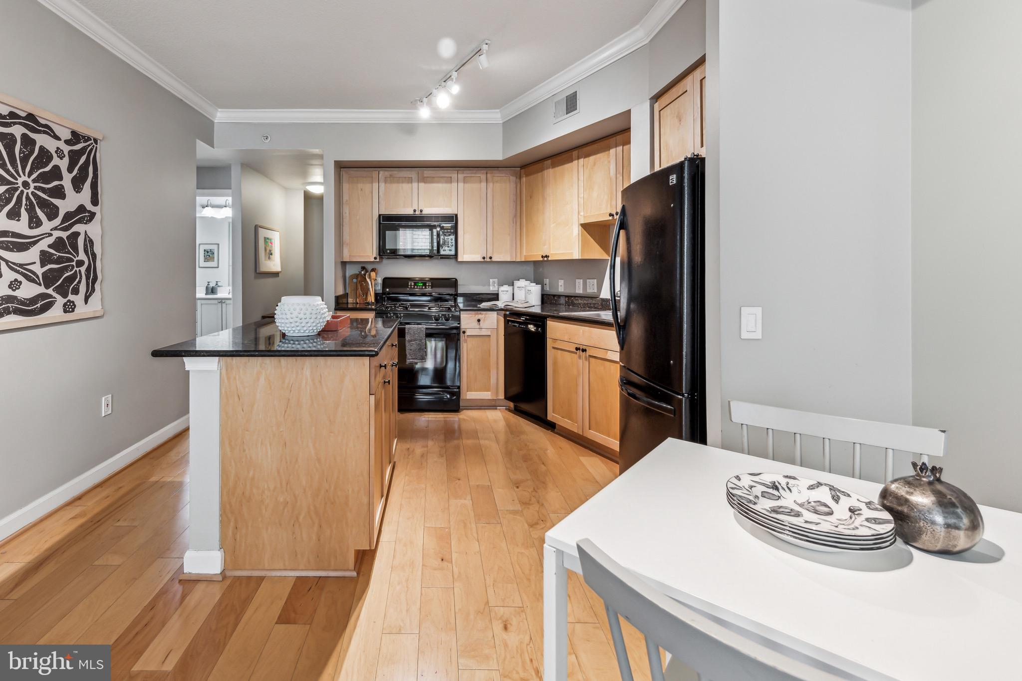 1441 Rhode Island Avenue Northwest, Unit 412 Washington, DC 20005 - Photo 16 of 37 a living room with stainless steel appliances kitchen island granite countertop furniture and a refrigerator