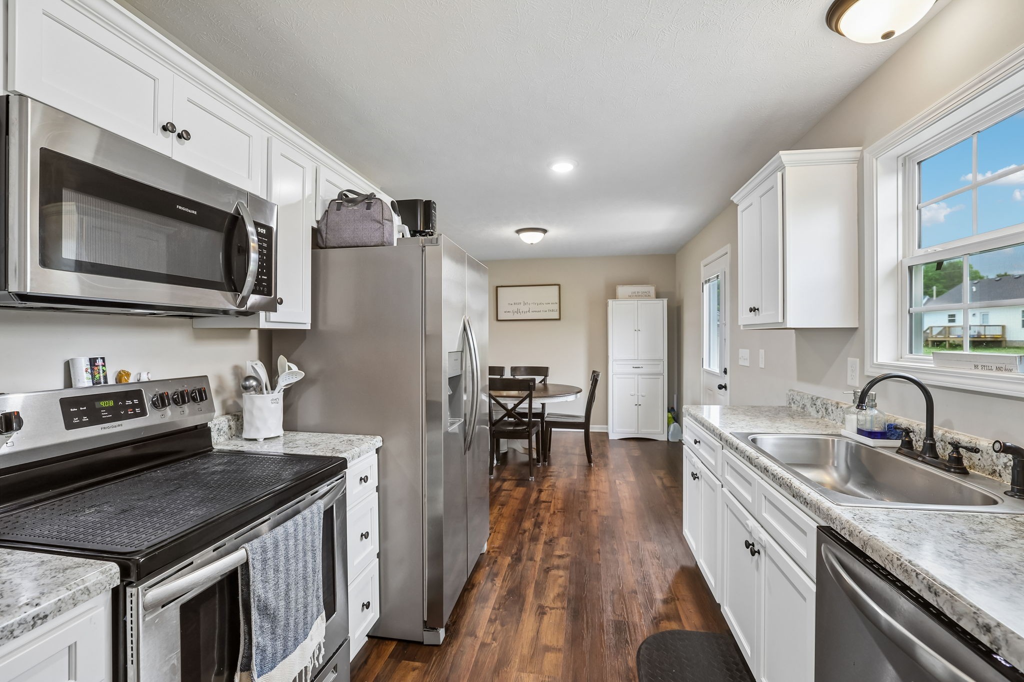1715 Old Belfast Road Lewisburg, TN 37091 - Photo 22 of 42 a kitchen with stainless steel appliances granite countertop a sink stove and refrigerator