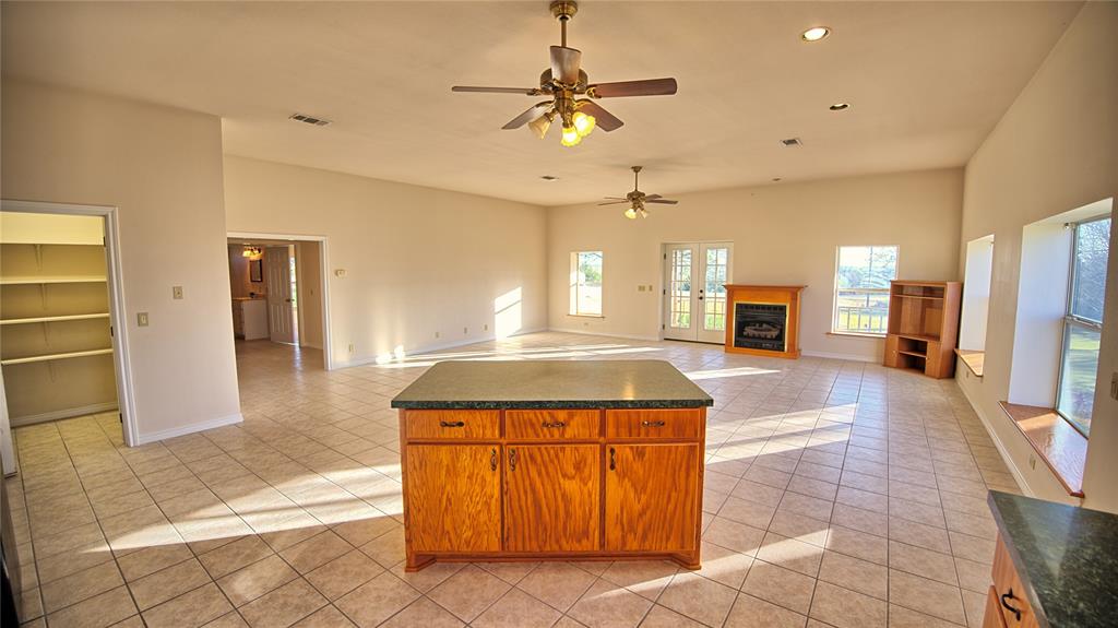 306 Dye Church Road St. Jo, TX 76265 - Photo 13 of 29 a kitchen with stainless steel appliances kitchen island granite countertop a refrigerator and a sink