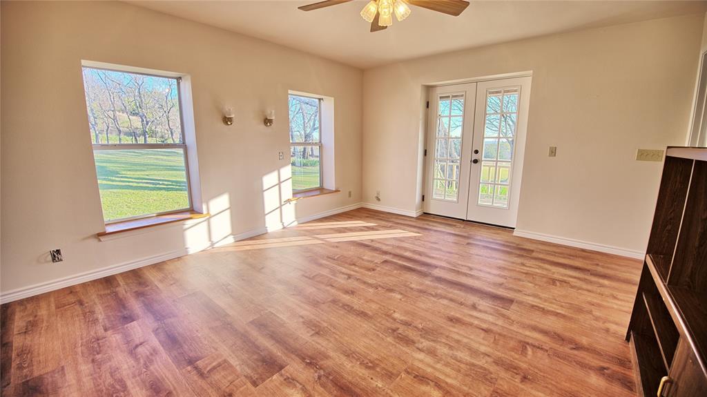 306 Dye Church Road St. Jo, TX 76265 - Photo 14 of 29 a view of an empty room with a window and wooden floor