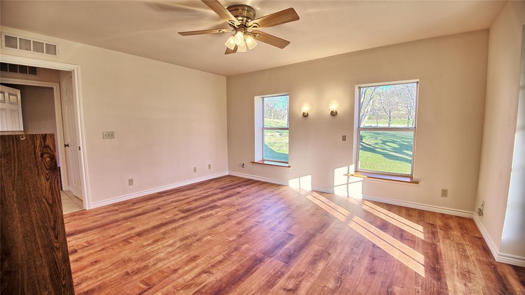 306 Dye Church Road St. Jo, TX 76265 - Photo 15 of 29 a view of empty room with window and wooden floor