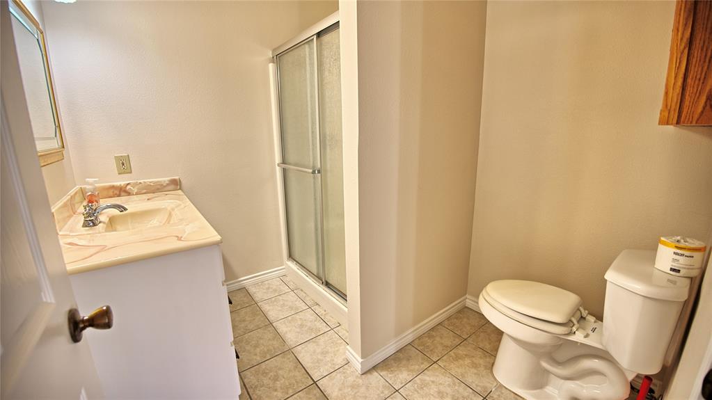 306 Dye Church Road St. Jo, TX 76265 - Photo 16 of 29 a bathroom with a sink a toilet and a shower