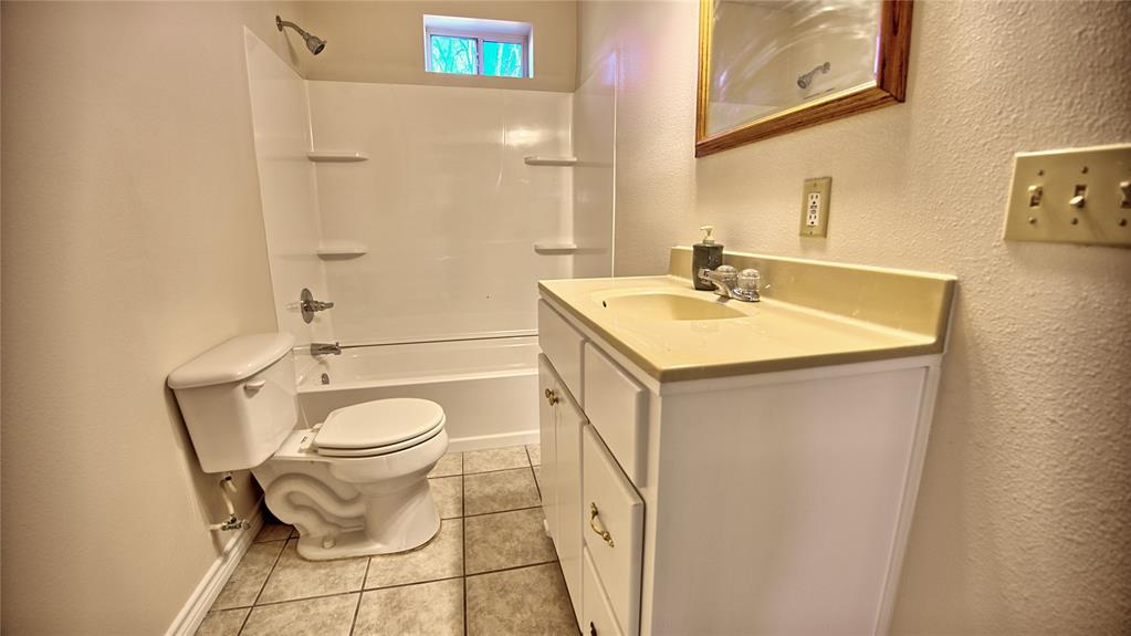 306 Dye Church Road St. Jo, TX 76265 - Photo 18 of 29 a bathroom with a sink toilet and shower