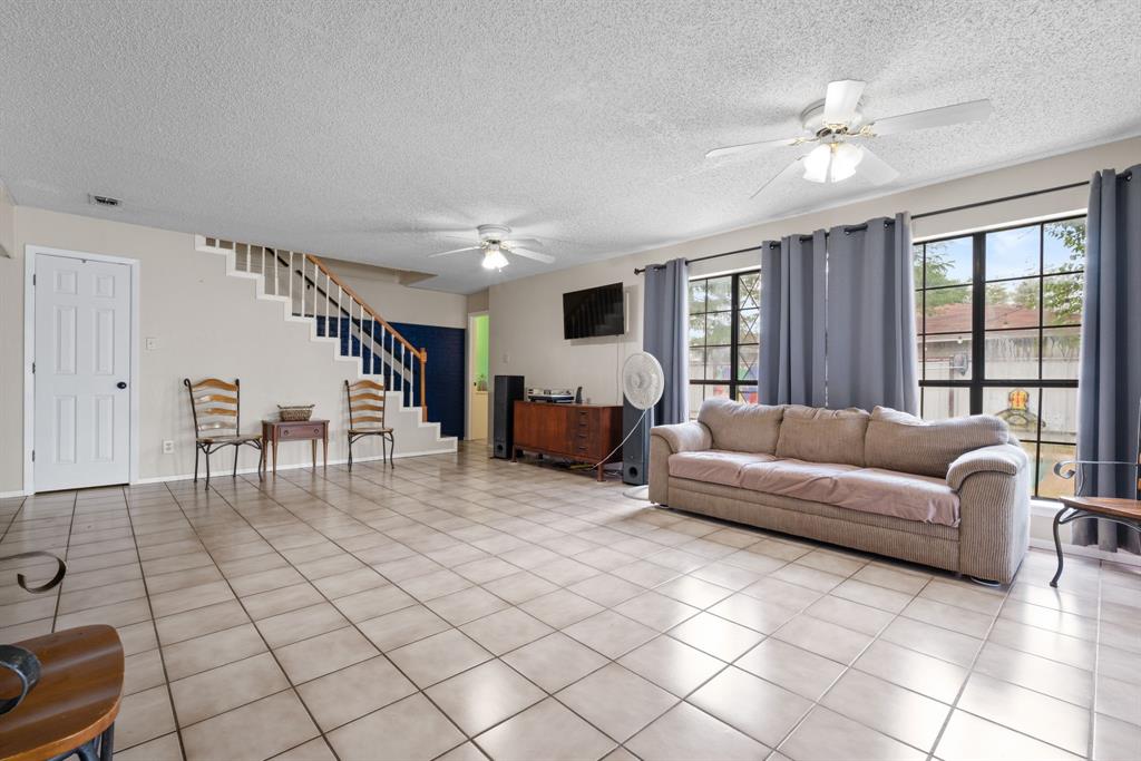 2200 Southeast 26th Avenue Mineral Wells, TX 76067 - Photo 13 of 28 a living room with furniture and a chandelier