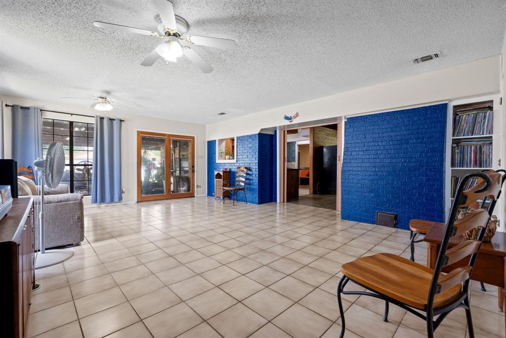 2200 Southeast 26th Avenue Mineral Wells, TX 76067 - Photo 14 of 28 a view of a livingroom with furniture and a chandelier fan