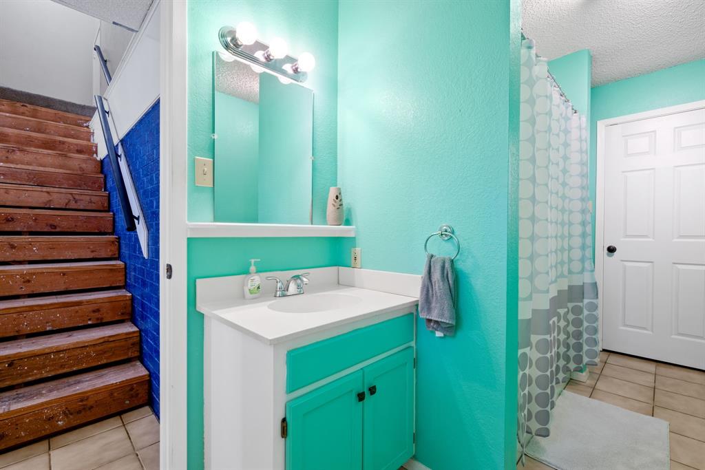 2200 Southeast 26th Avenue Mineral Wells, TX 76067 - Photo 16 of 28 a bathroom with a sink a toilet and shower