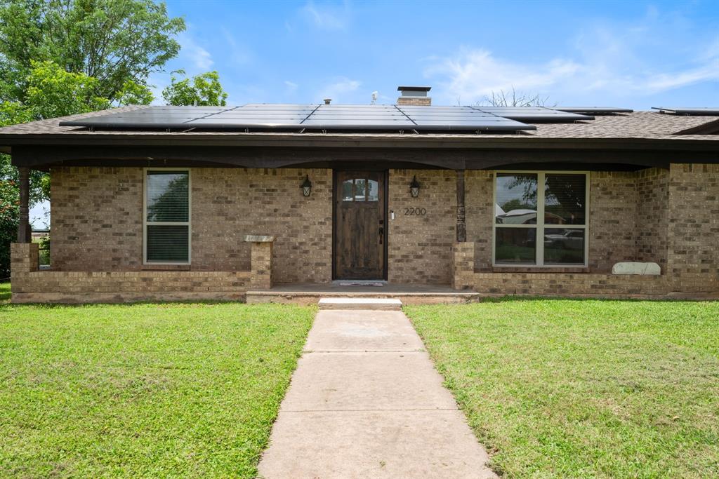 2200 Southeast 26th Avenue Mineral Wells, TX 76067 - Photo 2 of 28 a front view of a house with a garden and entertaining space