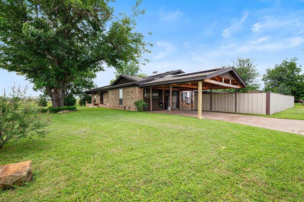 2200 Southeast 26th Avenue Mineral Wells, TX 76067 - Photo 28 of 28 a view of a house with a yard and large tree