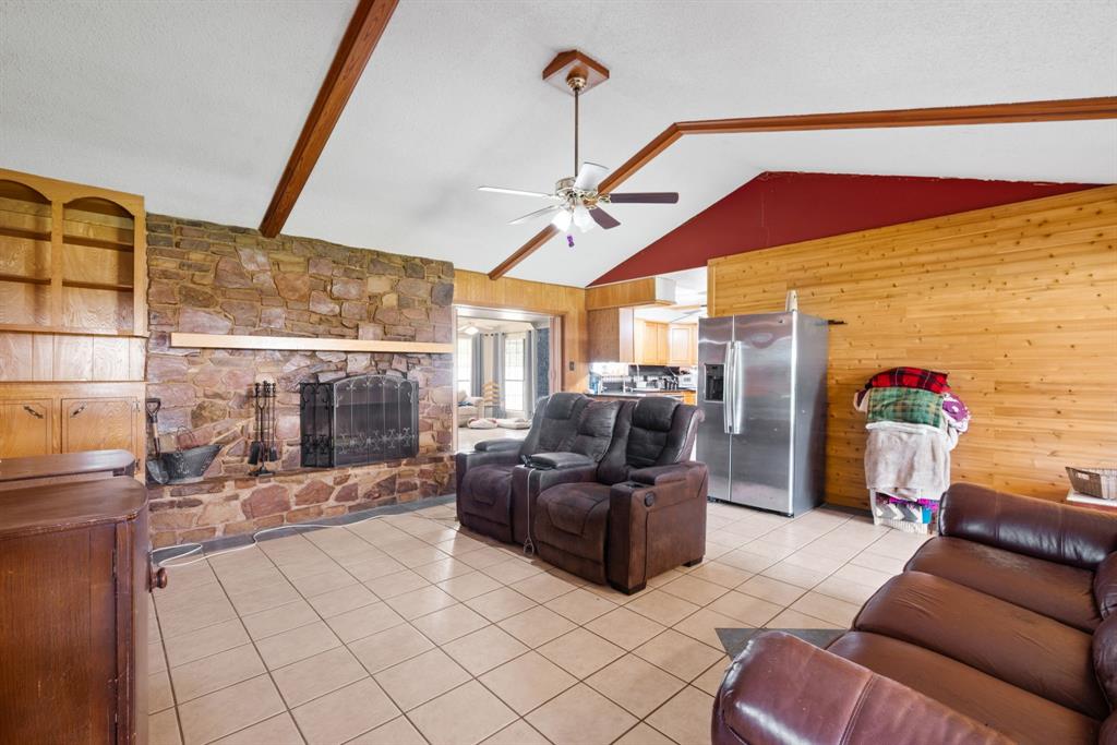 2200 Southeast 26th Avenue Mineral Wells, TX 76067 - Photo 5 of 28 a living room with furniture a flat screen tv and a floor to ceiling window