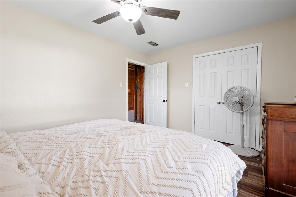 2200 Southeast 26th Avenue Mineral Wells, TX 76067 - Photo 8 of 28 a bedroom with a bed and a chandelier