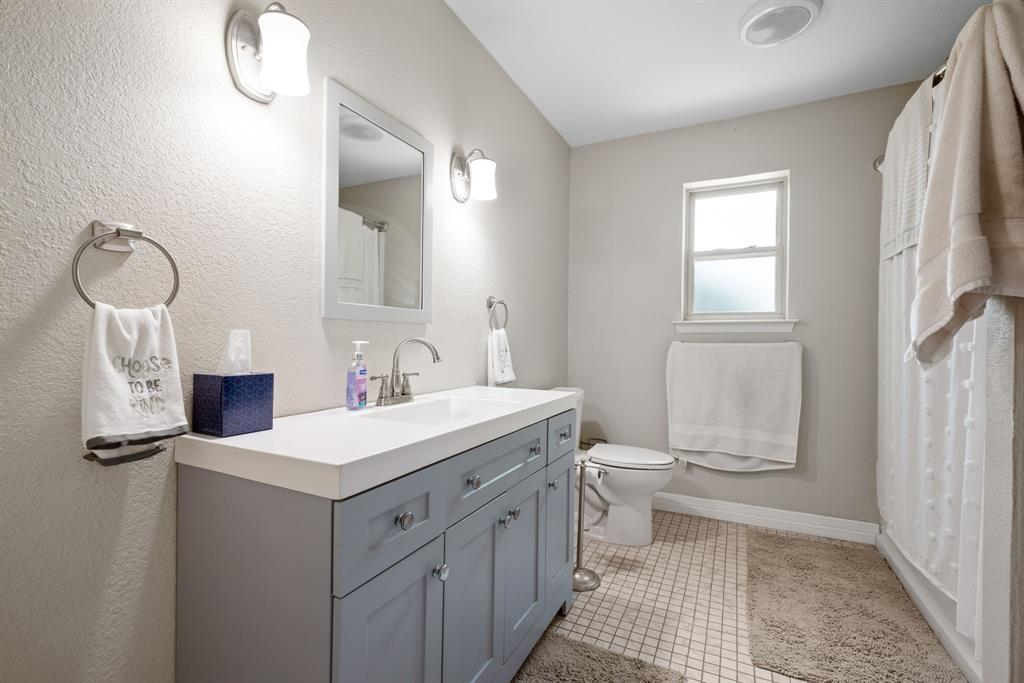 2200 Southeast 26th Avenue Mineral Wells, TX 76067 - Photo 9 of 28 a bathroom with a sink a toilet and a mirror