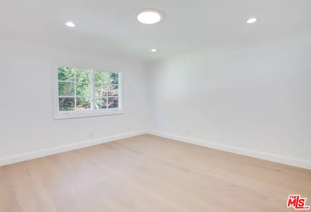a view of a chair and table in the garden