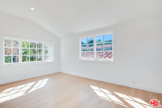 a view of a balcony with wooden floor