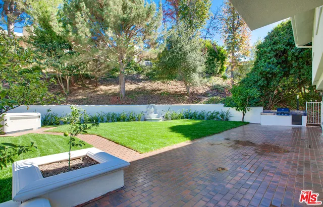 a view of a patio with table and chairs and potted plants