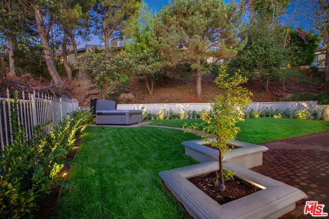 a dining hall with stainless steel appliances kitchen island granite countertop a stove a refrigerator a dining table and chairs with wooden floor