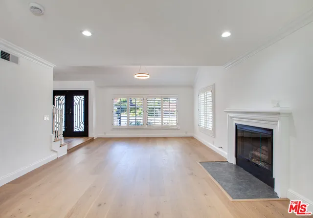 a view of a kitchen with a sink a fireplace and a window