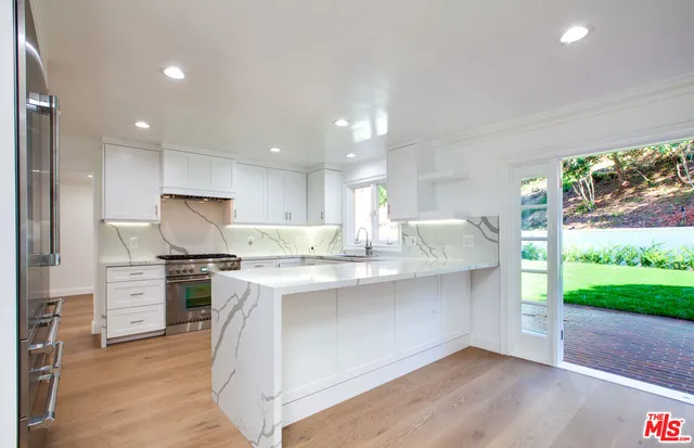 a view of an empty room with a fireplace and a window