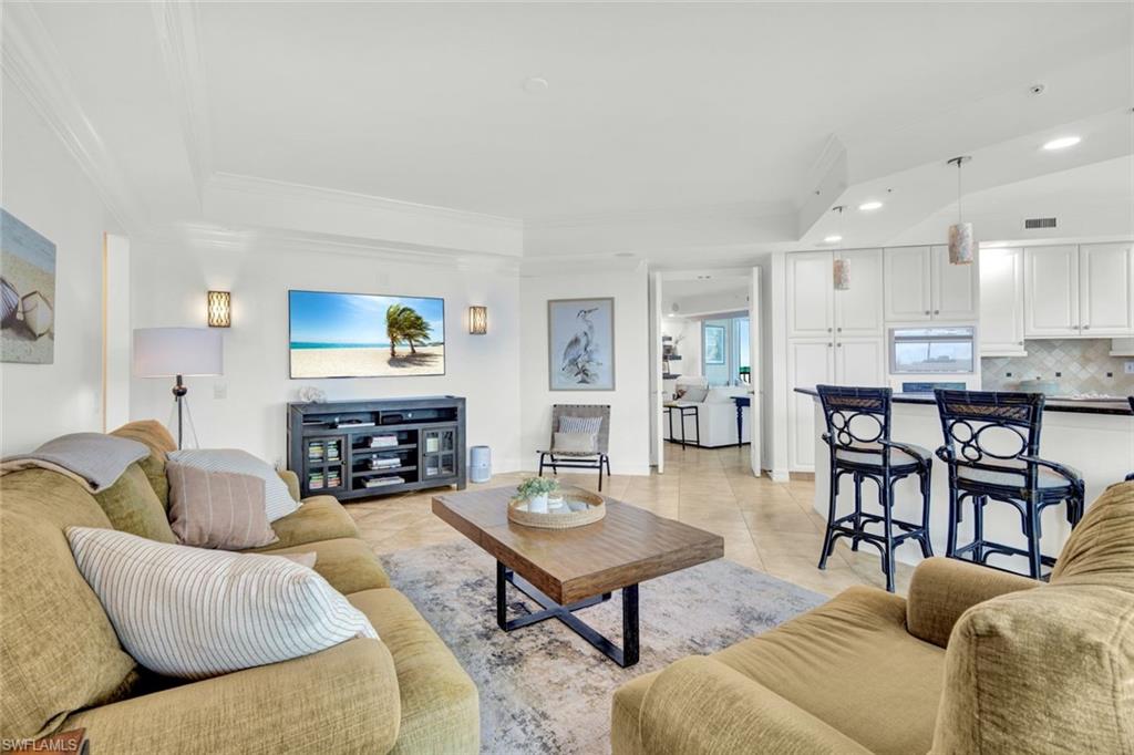 295 Grande Way, Unit 306 Naples, FL 34110 - Photo 17 of 48 a living room with fireplace furniture and a wooden floor