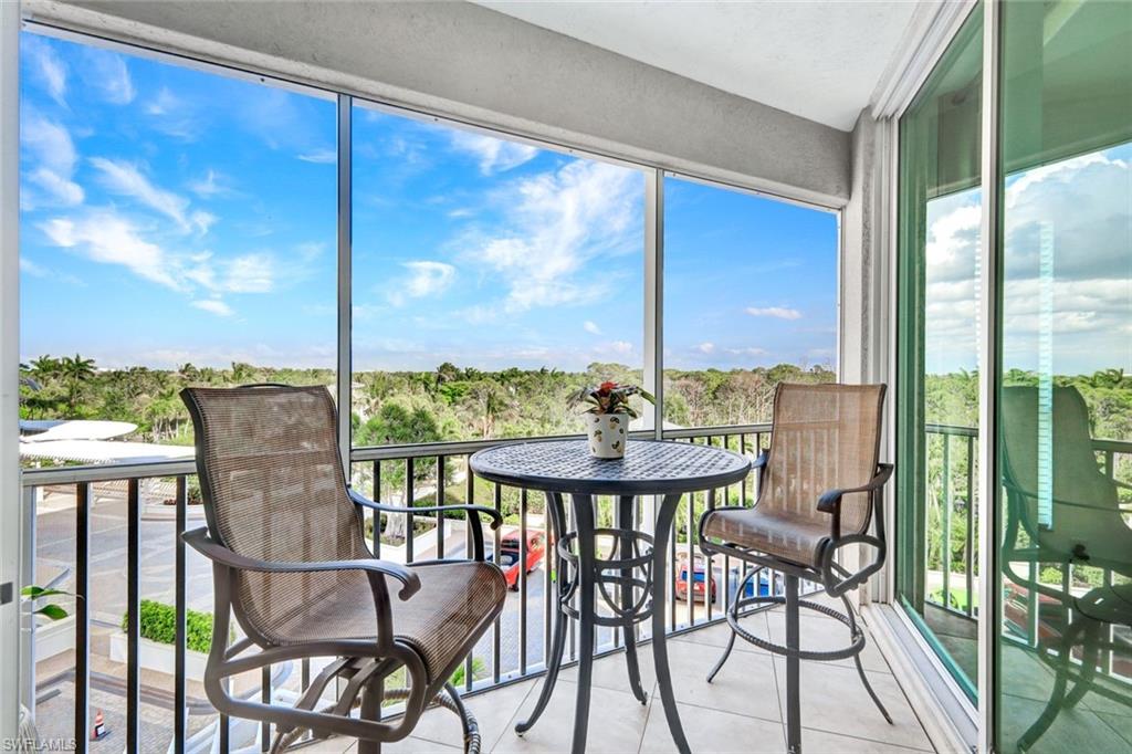 295 Grande Way, Unit 306 Naples, FL 34110 - Photo 19 of 48 a view of an outdoor dining space with furniture
