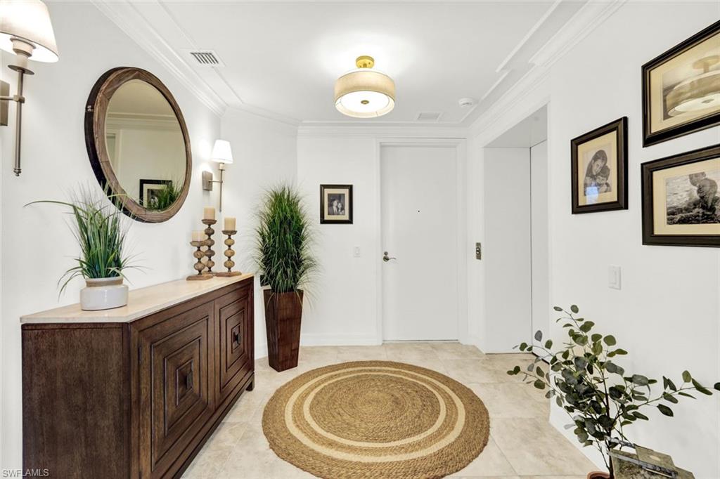 295 Grande Way, Unit 306 Naples, FL 34110 - Photo 2 of 48 a bathroom with a sink a mirror and a toilet