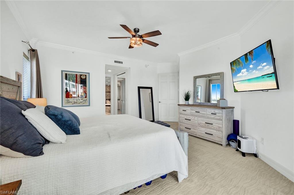 295 Grande Way, Unit 306 Naples, FL 34110 - Photo 21 of 48 a bedroom with a bed and a dresser