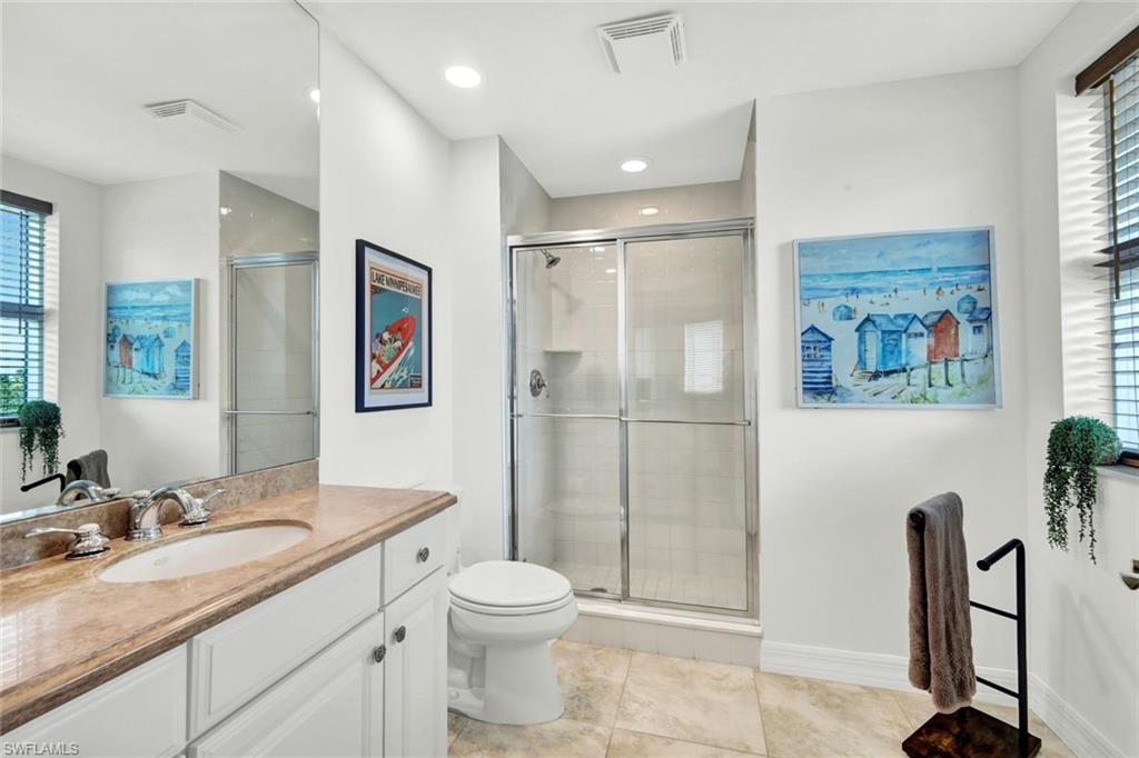 295 Grande Way, Unit 306 Naples, FL 34110 - Photo 25 of 48 a bathroom with a granite countertop sink toilet and shower