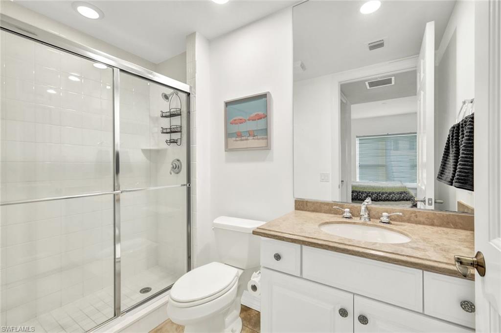 295 Grande Way, Unit 306 Naples, FL 34110 - Photo 27 of 48 a bathroom with a granite countertop sink toilet and shower