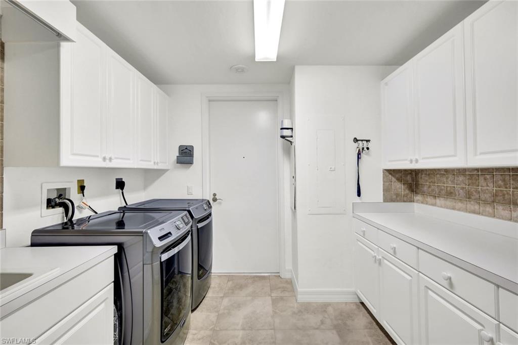 295 Grande Way, Unit 306 Naples, FL 34110 - Photo 28 of 48 a kitchen with stainless steel appliances granite countertop a sink a stove and a refrigerator