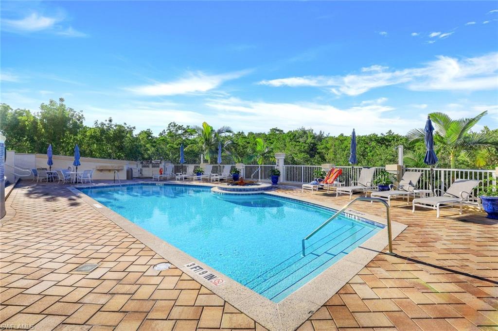 295 Grande Way, Unit 306 Naples, FL 34110 - Photo 29 of 48 a view of swimming pool with outdoor seating